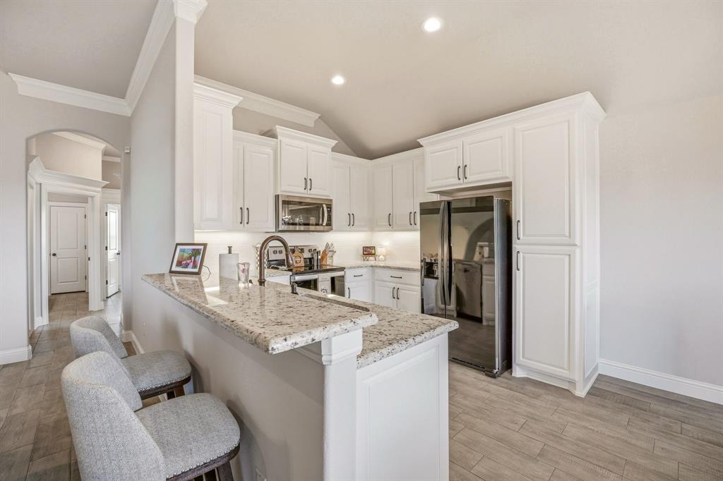 601 Violet Tolar, TX 76476 - Photo 5 of 26 a kitchen with stainless steel appliances granite countertop a refrigerator stove microwave and sink