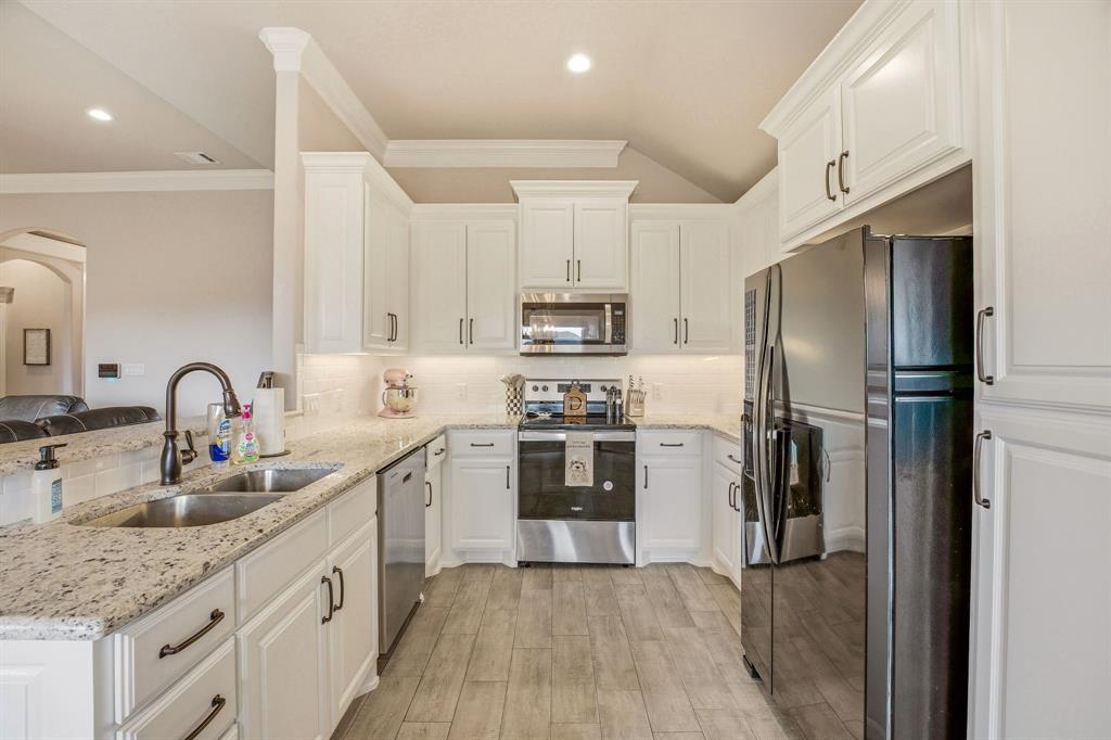 601 Violet Tolar, TX 76476 - Photo 6 of 26 a kitchen with stainless steel appliances granite countertop a refrigerator a sink a stove and white cabinets