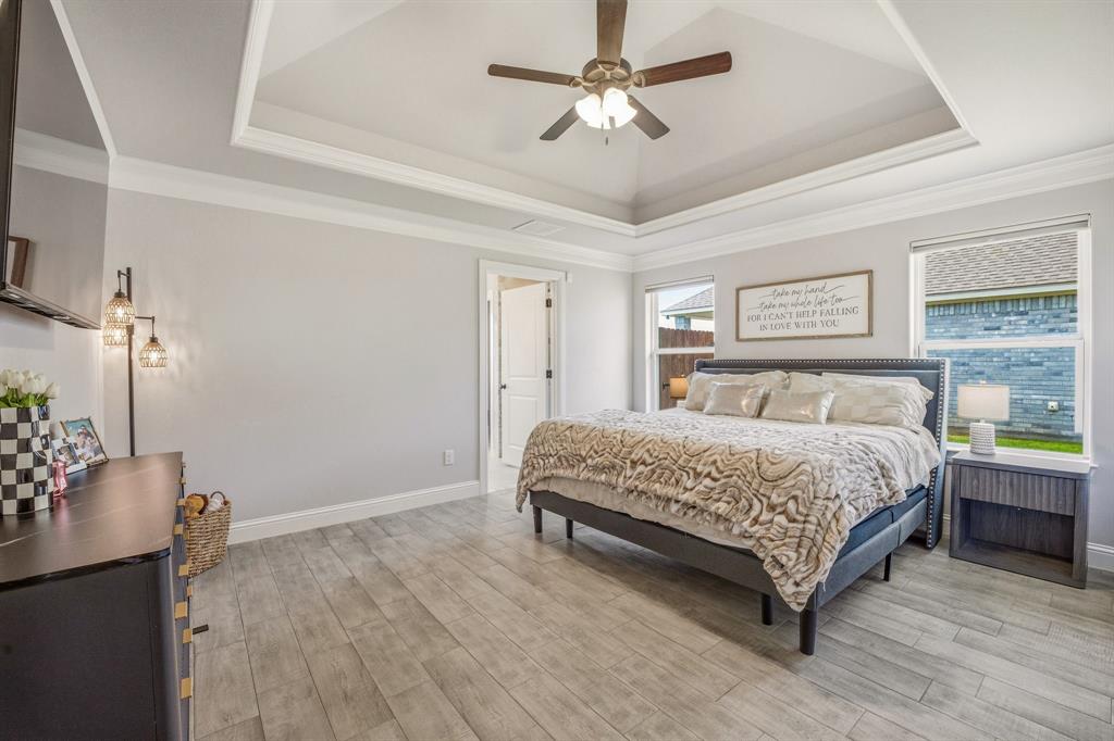 601 Violet Tolar, TX 76476 - Photo 10 of 26 a bedroom with a large bed chandelier and a window