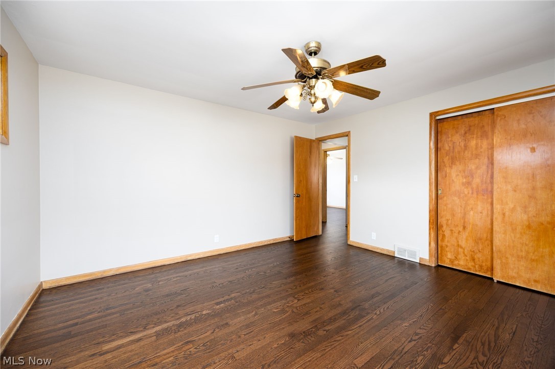 364 Mowbray Road Akron, OH 44333 - Photo 26 of 44 Unfurnished bedroom featuring dark wood floors, a ceiling fan, and a closet