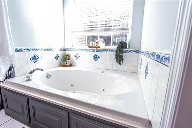 a kitchen with granite countertop a sink stainless steel appliances and cabinets
