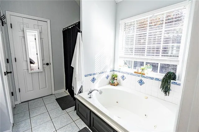 a kitchen with stainless steel appliances granite countertop white cabinets a refrigerator a stove a sink and dishwasher with wooden floor