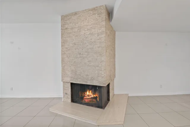 a bathroom with a granite countertop sink and a window