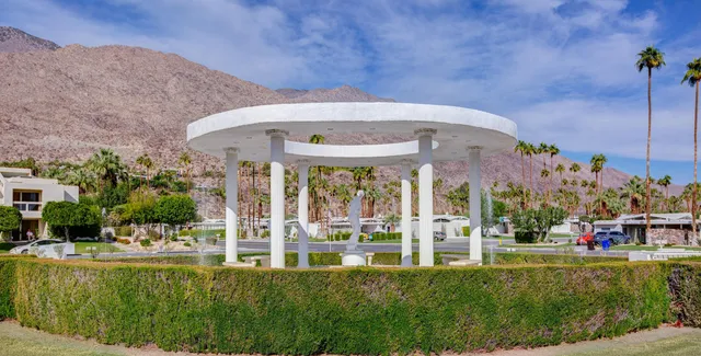 an empty room with windows and fireplace