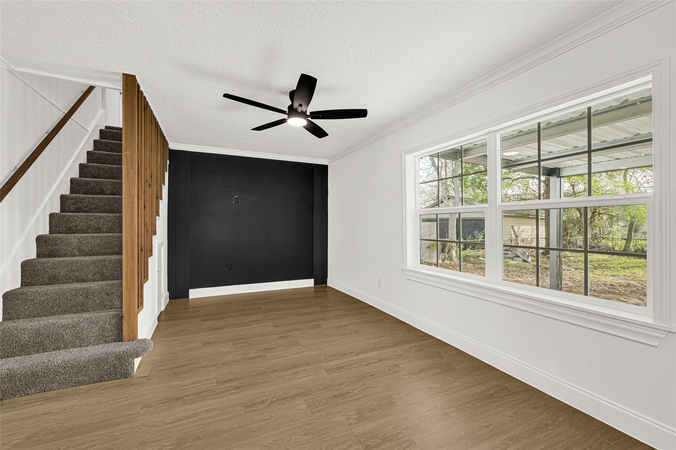 513 Main Street Pasadena, TX 77506 - Photo 15 of 35 a view of empty room with wooden floor and fan