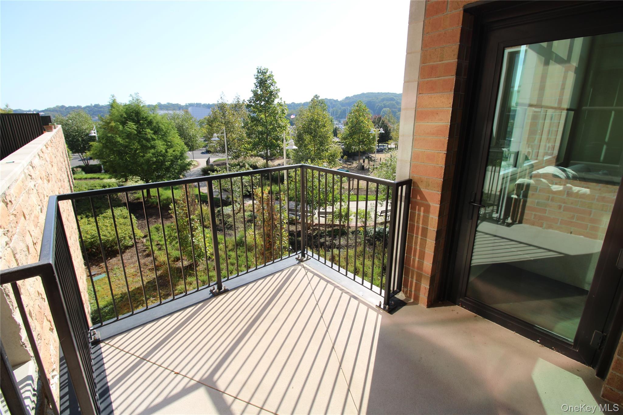 100 Garvies Point Road, Unit 1039 Glen Cove, NY 11542 - Photo 11 of 12 a view of a balcony with wooden floor