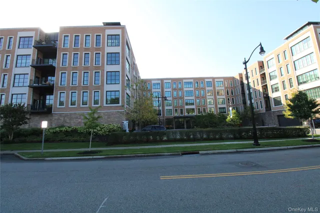 a view of a tall building next to a yard