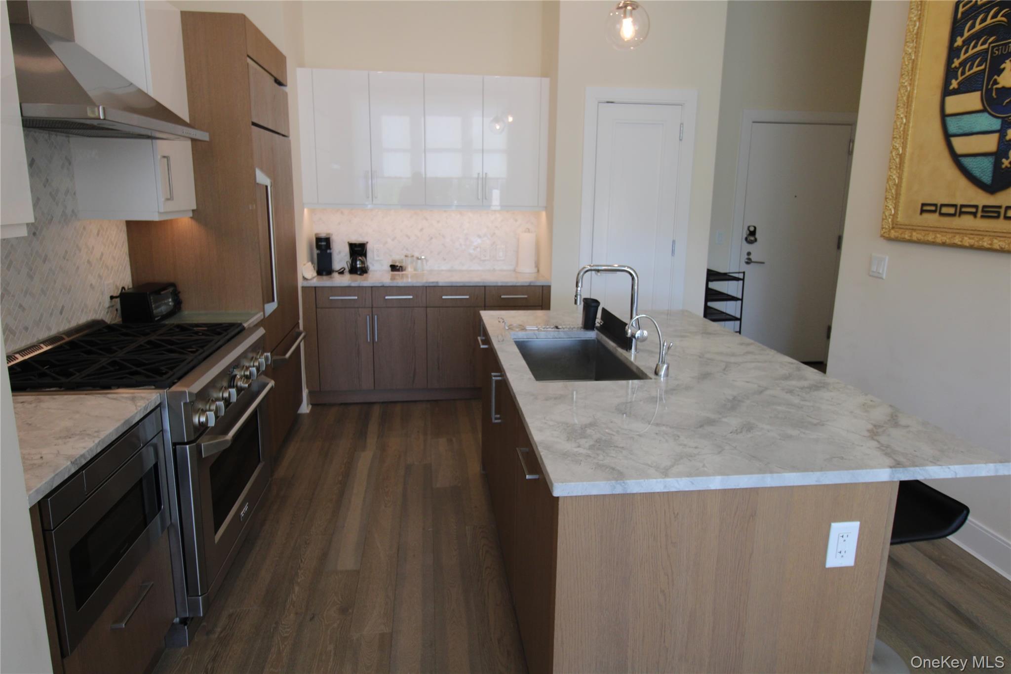 100 Garvies Point Road, Unit 1039 Glen Cove, NY 11542 - Photo 6 of 12 a kitchen with a sink a stove and cabinets