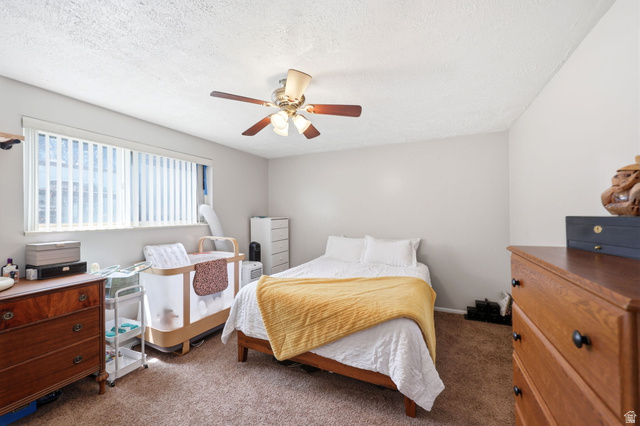 314 West Center Street, Unit F102 Bountiful, UT 84010 - Photo 17 of 29 Bedroom featuring a window with vertical blinds, a ceiling fan with integrated lighting, and neutral wall paint