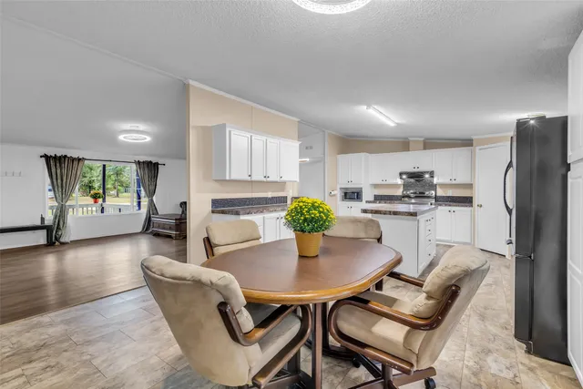 a dining room with furniture and wooden floor