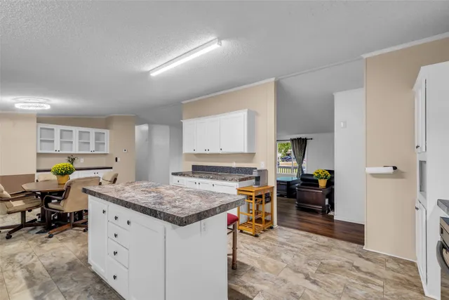 a view of kitchen island with granite countertop lots of counter top space