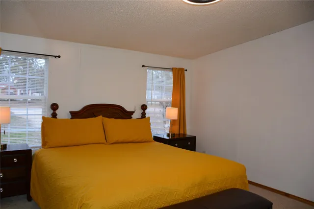 a bedroom with a bed and window