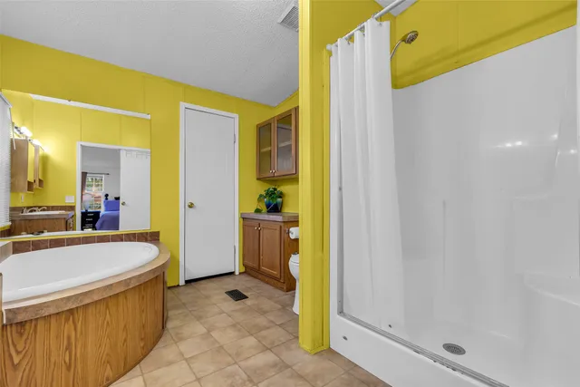 a large bathroom with a tub and shower