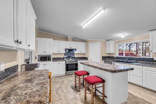 a kitchen with stainless steel appliances granite countertop a sink and cabinets