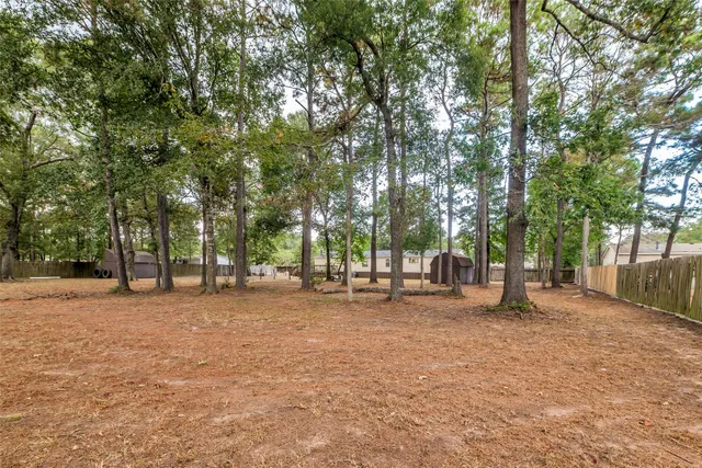a backyard of a house with large trees