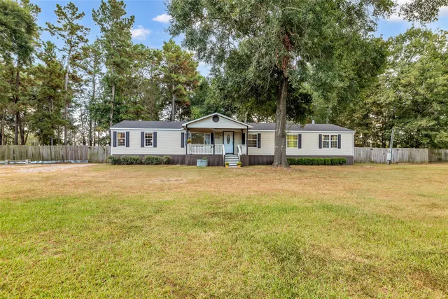 a house view with swimming pool in front of it