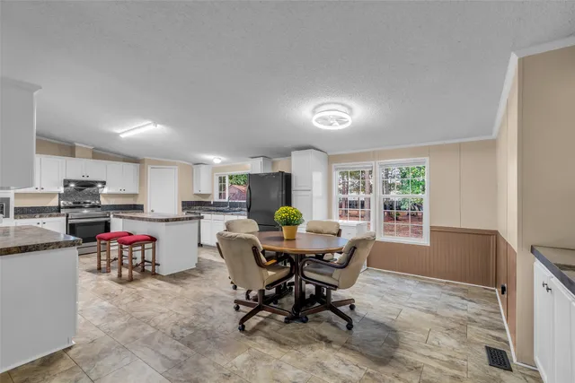 a view of a dining room with furniture window and outside view