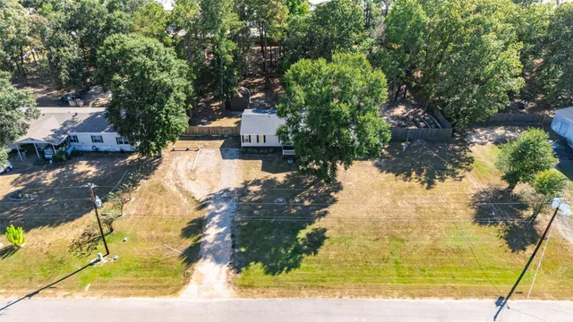a view of a yard with wooden fence