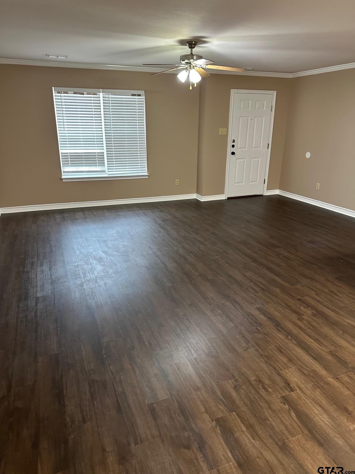 325 Princess Place Tyler, TX 75704 - Photo 3 of 5 a view of an empty room with wooden floor and a window