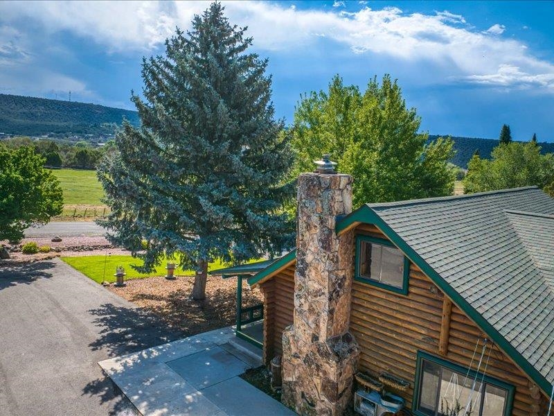17969 Surface Creek Road Cedaredge, CO 81413 - Photo 33 of 34 a view of a backyard with plants and a patio