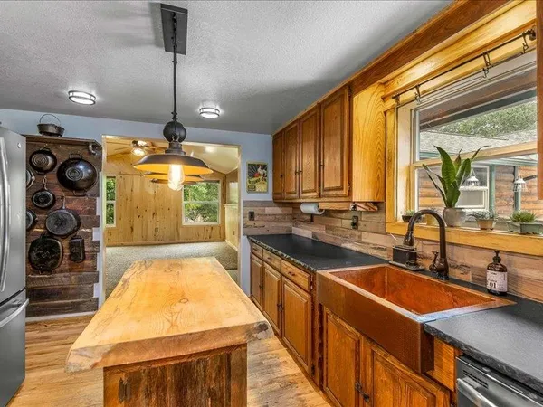 a kitchen with stainless steel appliances a stove and a sink