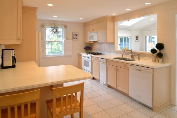 11 Cornell Road Marblehead, MA 01945 - Photo 9 of 28 a kitchen with a sink dishwasher stove and white cabinets with wooden floor