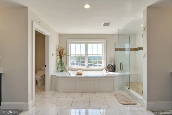 a spacious bathroom with a bathtub and sink