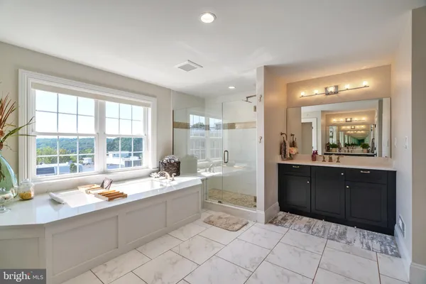 a large bathroom with a large tub and sink