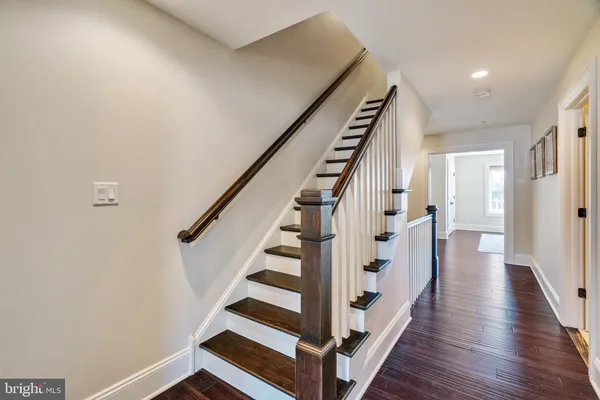 a view of a hallway with wooden floor and entryway
