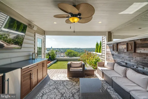 a swimming pool with outdoor seating and barbeque oven