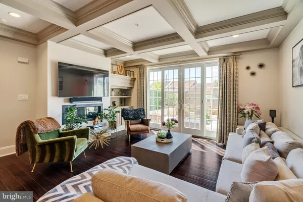 a living room with furniture a flat screen tv and a large window