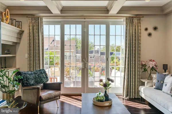a living room with furniture and floor to ceiling windows