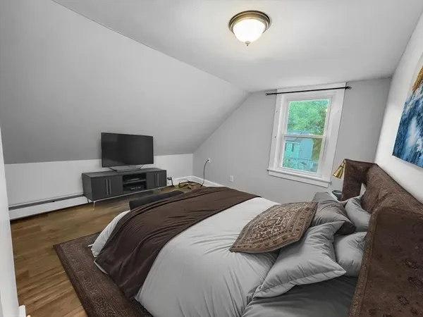 a bedroom with a bed and a flat screen tv