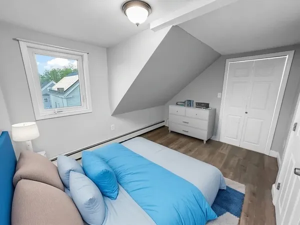 a bedroom with a bed and a window