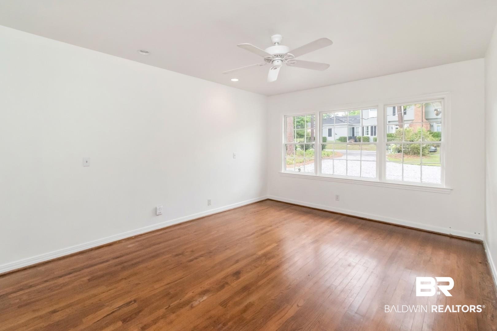 4 Turnout Lane Mobile, AL 36608 - Photo 22 of 53 Empty room with dark wood-style flooring and a ceiling fan