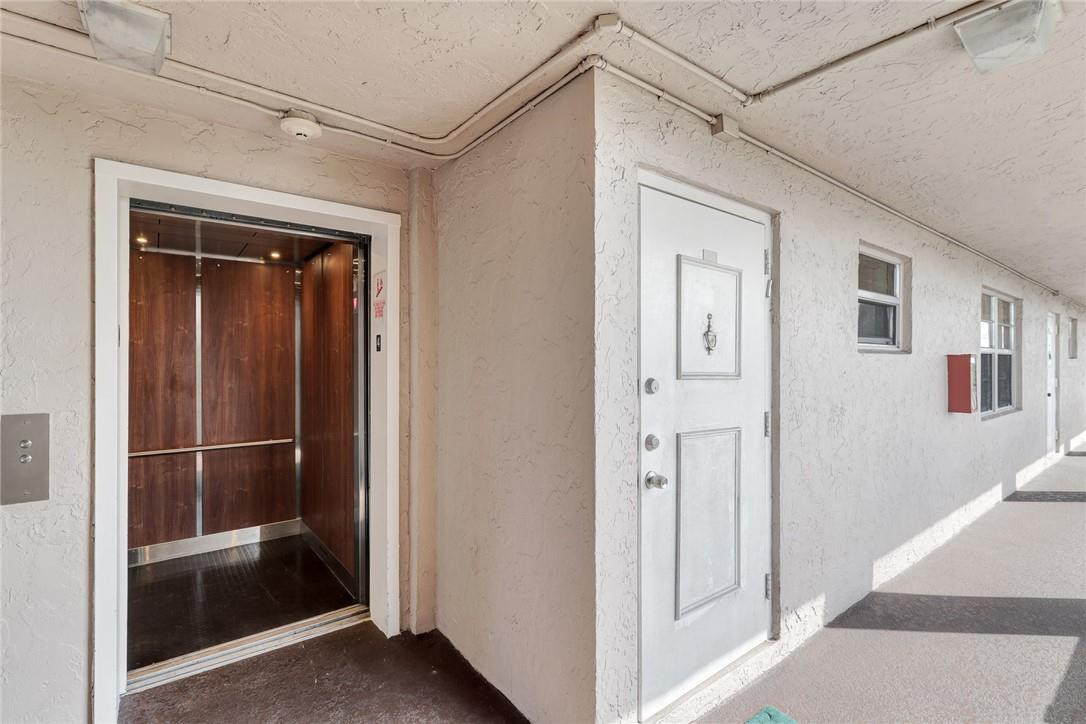 1075 Riverside Drive, Unit 405 Coral Springs, FL 33071 - Photo 9 of 22 Next to Elevator