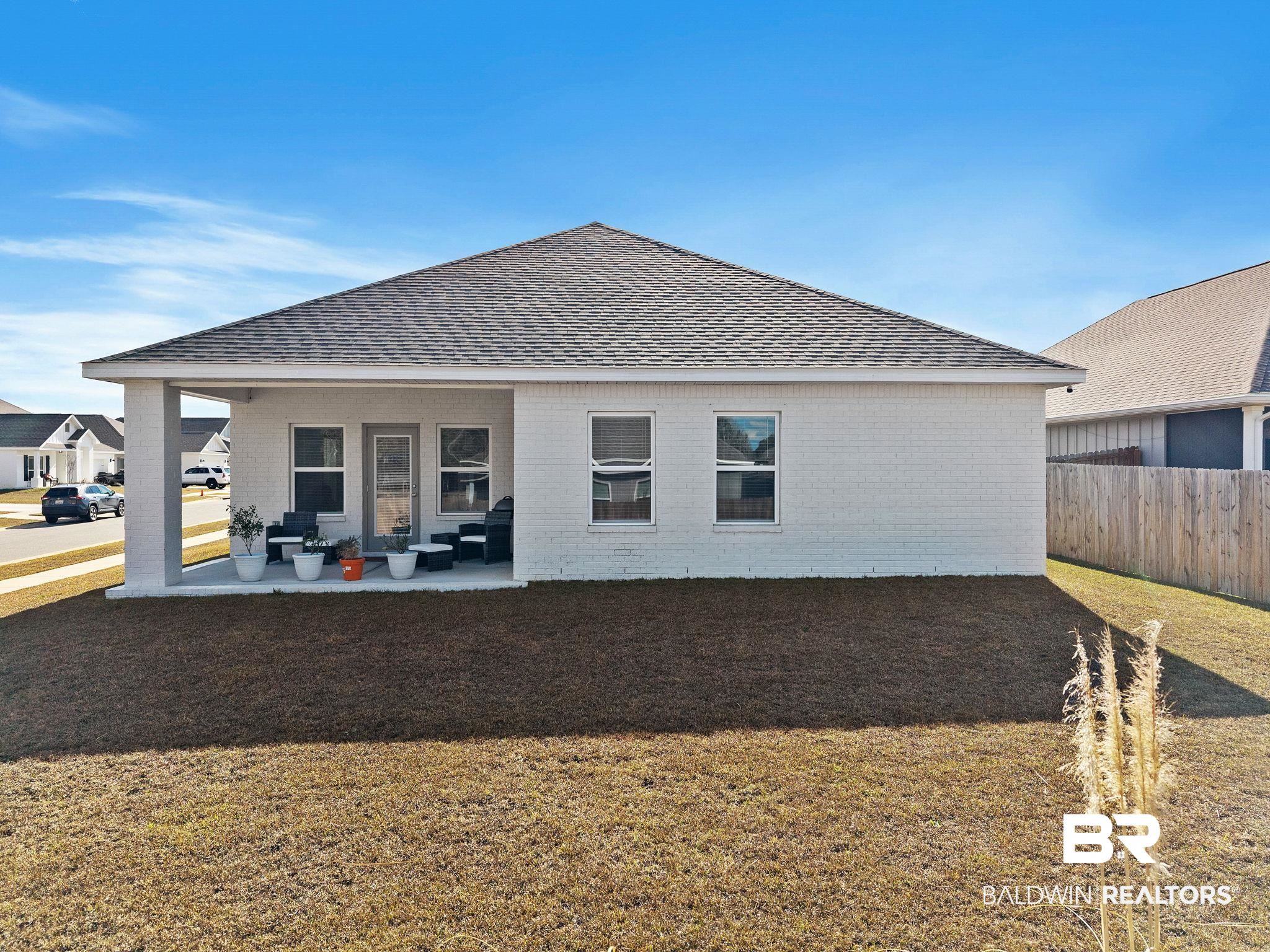 12919 Torrent Road Fairhope, AL 36532 - Photo 68 of 74 Back of house featuring a patio, brick siding, and roof with shingles