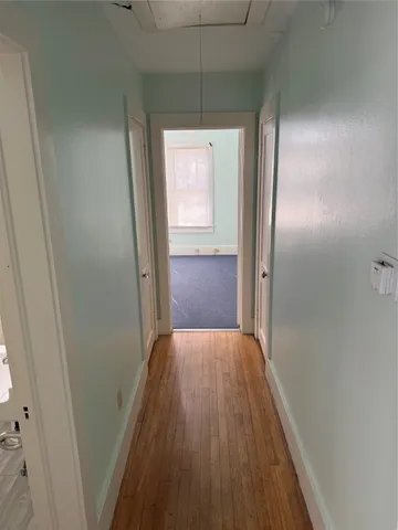 a view of hallway with wooden floor