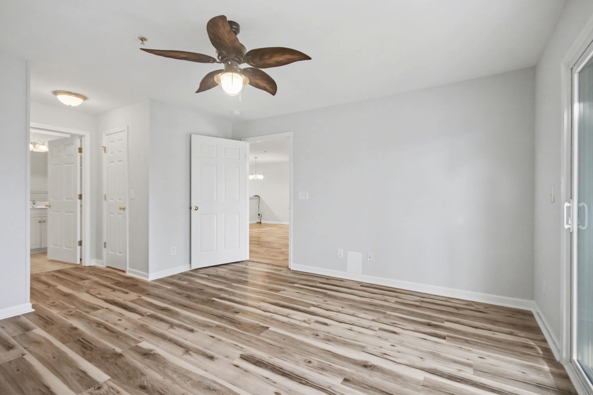 4853 Meadowsweet Drive, Unit 1807 Myrtle Beach, SC 29579 - Photo 22 of 40 Primary bedroom with light wood-type flooring, ceiling fan and ensuite bathroom