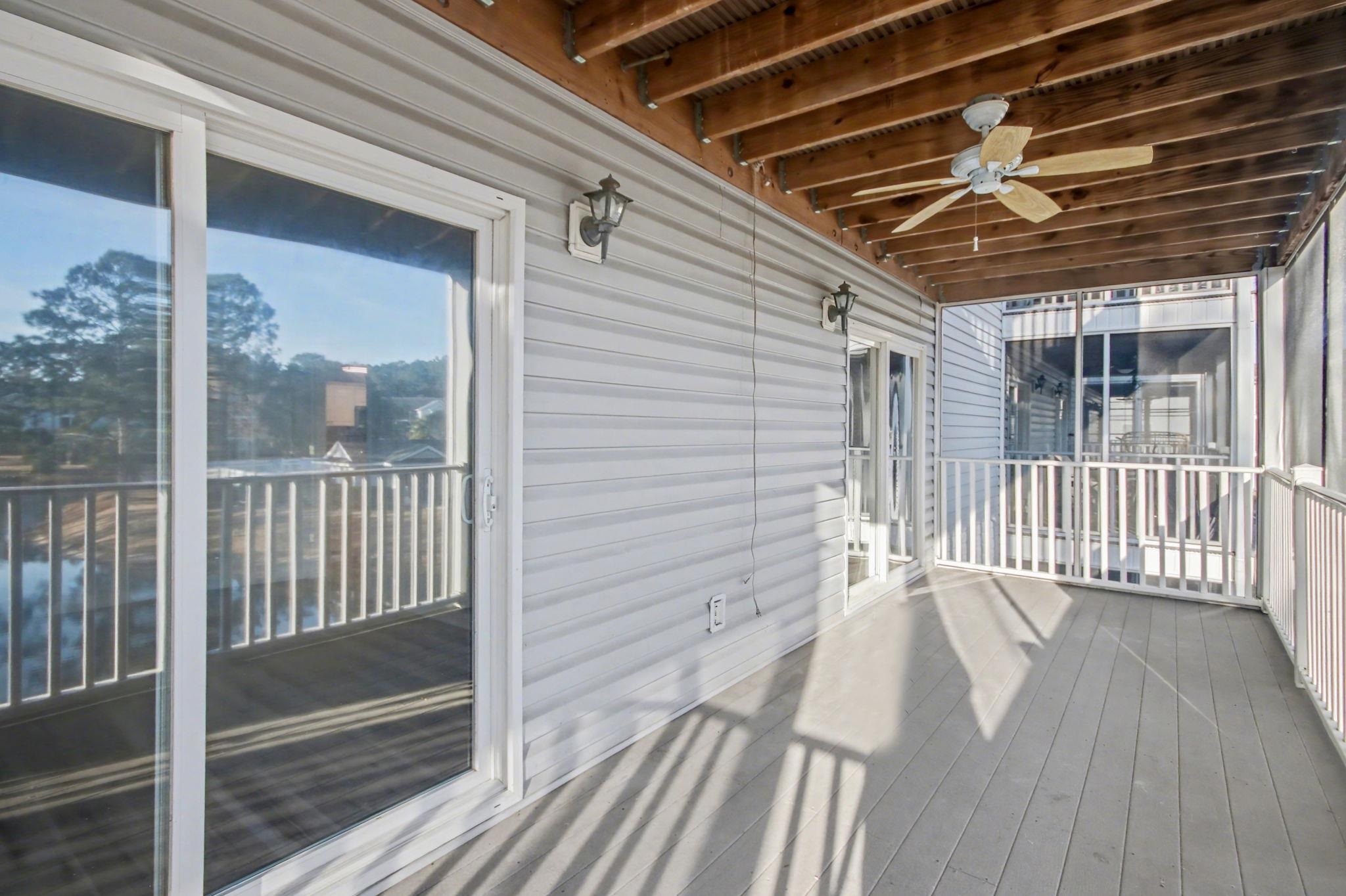 4853 Meadowsweet Drive, Unit 1807 Myrtle Beach, SC 29579 - Photo 29 of 40 Screen porch featuring a water view and a ceiling fan with access from the living room and the primary suite