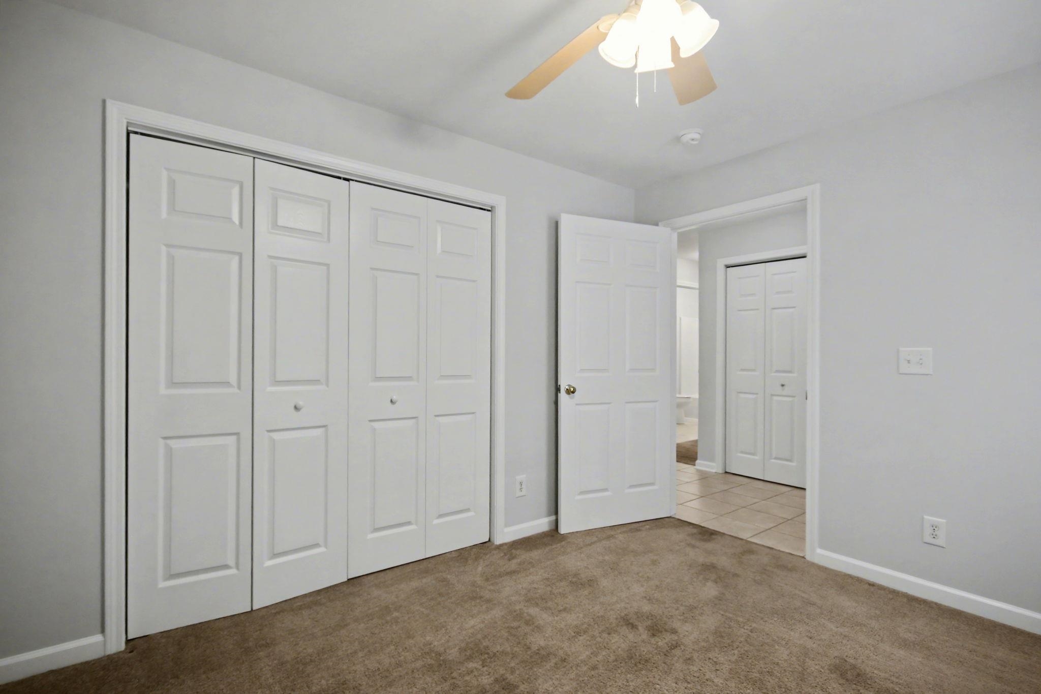 4853 Meadowsweet Drive, Unit 1807 Myrtle Beach, SC 29579 - Photo 7 of 40 Front right bedroom featuring a closet, light carpet and ceiling fan