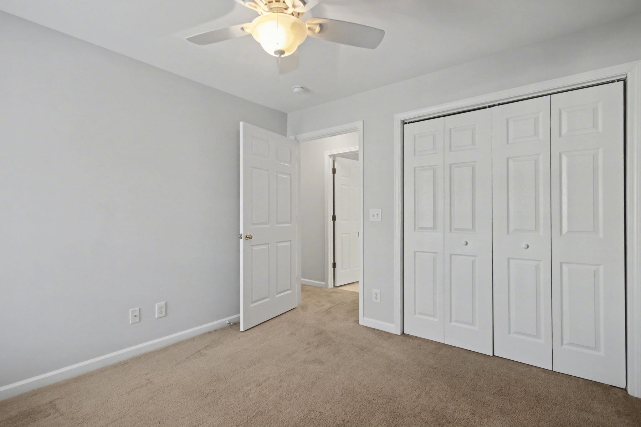 4853 Meadowsweet Drive, Unit 1807 Myrtle Beach, SC 29579 - Photo 9 of 40 Front left bedroom featuring a closet, light carpet and ceiling fan