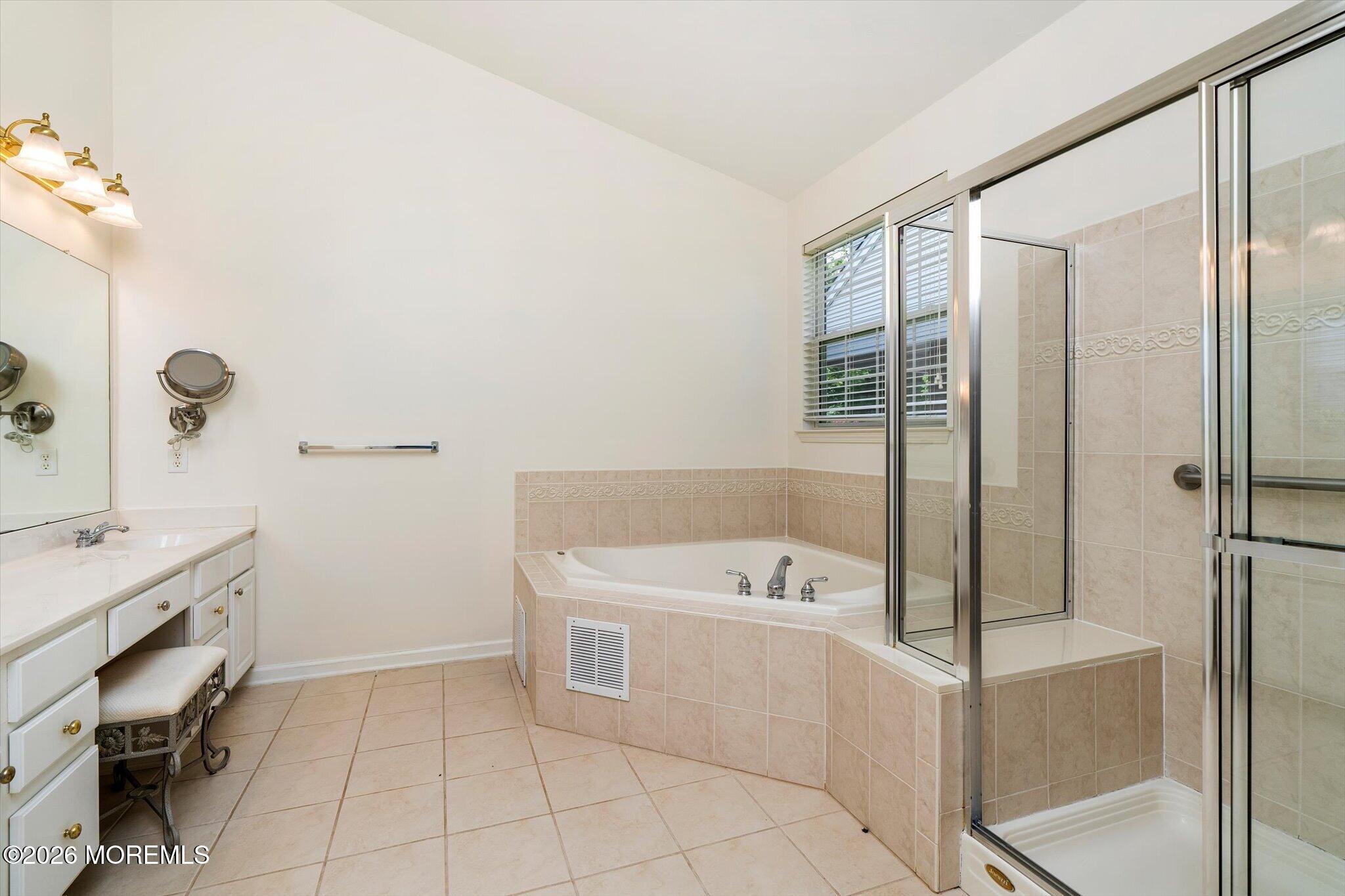 10 Powderhorn Way Allentown, NJ 08501 - Photo 16 of 27 a bathroom with a tub a sink and a mirror