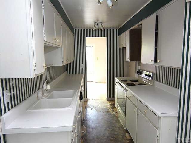 1764 Quail Ridge Road Raleigh, NC 27609 - Photo 5 of 10 a kitchen with stainless steel appliances granite countertop a sink stove and refrigerator
