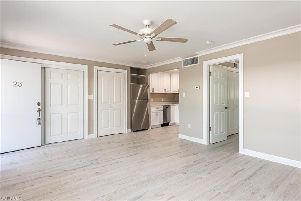780 10th Avenue South, Unit 23 Naples, FL 34102 - Photo 11 of 15 a view of a livingroom with a ceiling fan & entryway