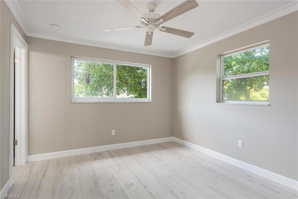 780 10th Avenue South, Unit 23 Naples, FL 34102 - Photo 13 of 15 a view of an empty room with wooden floor and a window