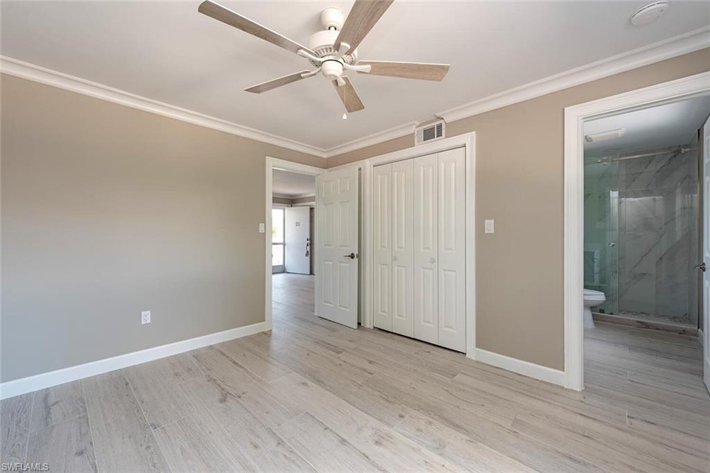 780 10th Avenue South, Unit 23 Naples, FL 34102 - Photo 14 of 15 an empty room with wooden floor and ceiling fan