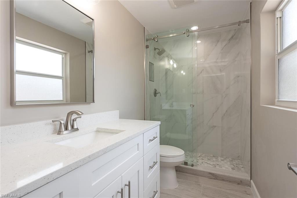 780 10th Avenue South, Unit 23 Naples, FL 34102 - Photo 15 of 15 a bathroom with a sink a toilet and shower