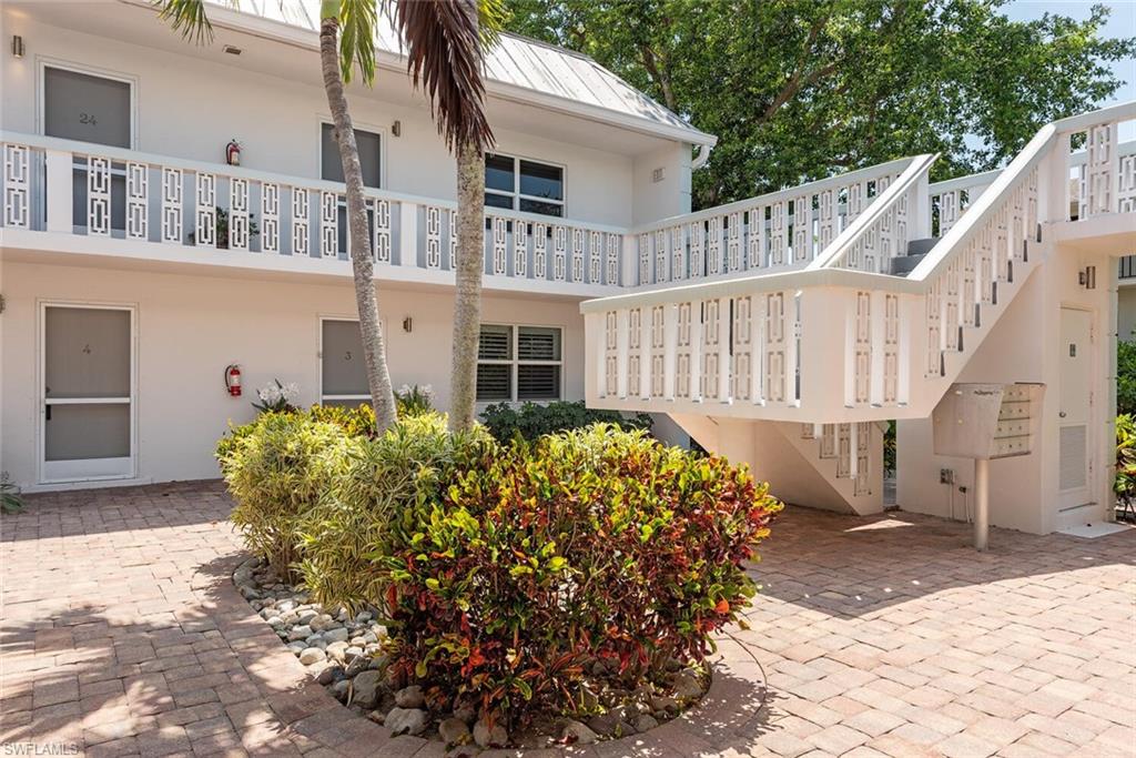 780 10th Avenue South, Unit 23 Naples, FL 34102 - Photo 2 of 15 a view of a house with wooden fence
