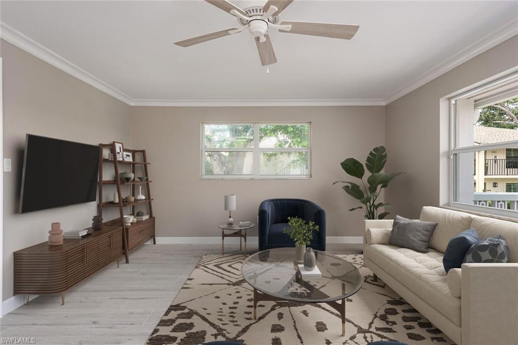 780 10th Avenue South, Unit 23 Naples, FL 34102 - Photo 5 of 15 a living room with furniture and a flat screen tv